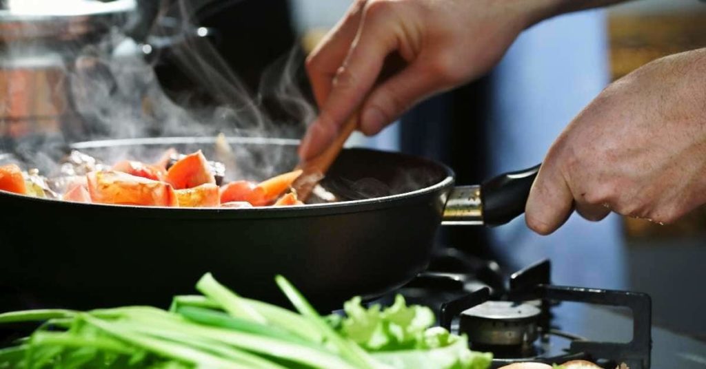 Eat vegetables for weight loss. Man cooking vegetables.